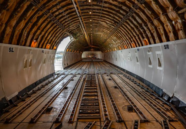 portfolio-01 Empty cargo plane interior showcasing spacious hold, ready for freight loading.